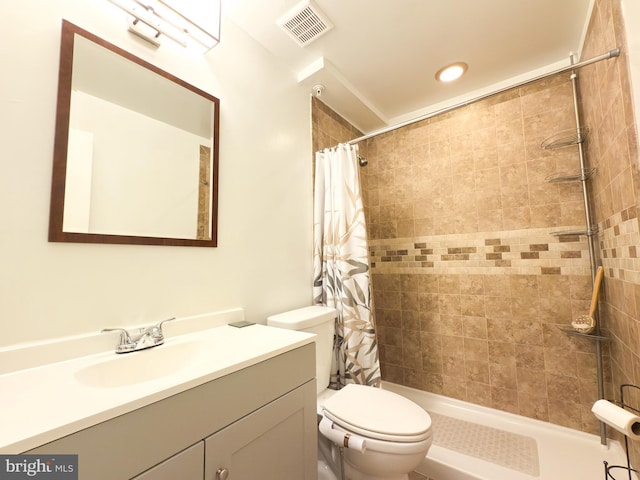 bathroom with walk in shower, vanity, and toilet