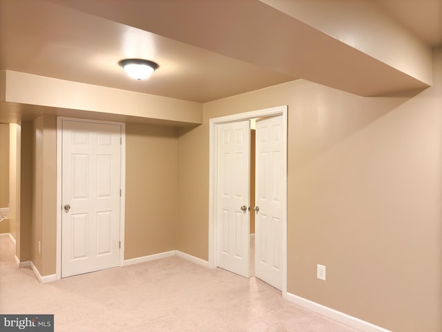 basement with light colored carpet