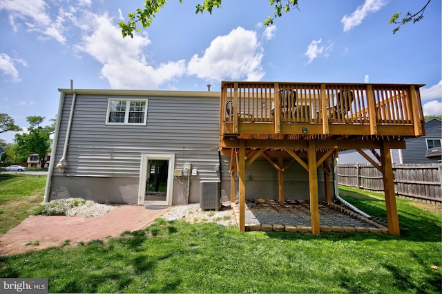 6406 Holyoke Dr, Annandale, VA 22003 - back of property with a lawn, fence, a wooden deck, and central AC unit