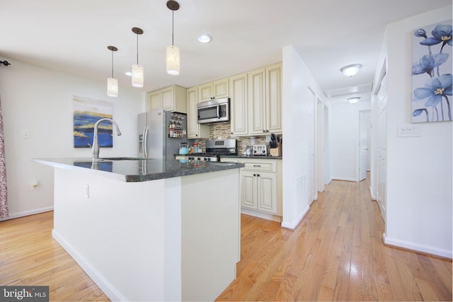 6406 Holyoke Dr, Annandale, VA 22003 - kitchen with a sink, light wood finished floors, appliances with stainless steel finishes, and cream cabinetry