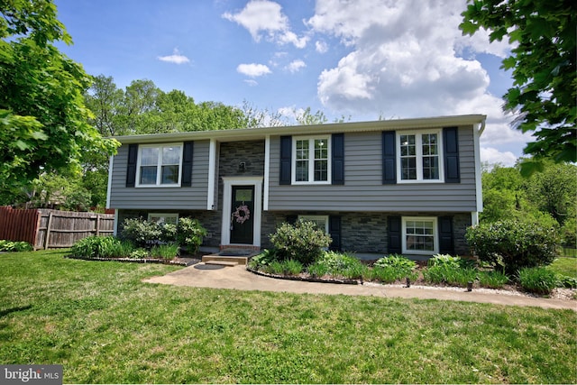 6406 Holyoke Dr, Annandale, VA 22003 - split foyer home featuring stone siding, fence, and a front yard