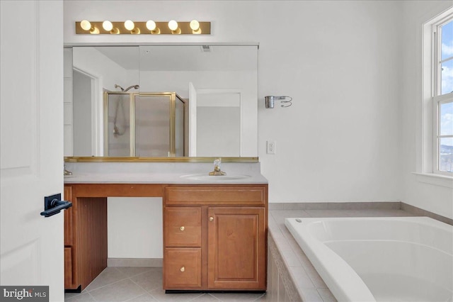 bathroom with tile patterned flooring, shower with separate bathtub, and vanity