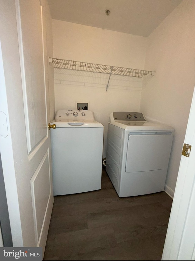 laundry room featuring separate washer and dryer and dark hardwood / wood-style floors