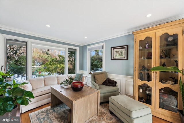 interior space with crown molding and light hardwood / wood-style flooring