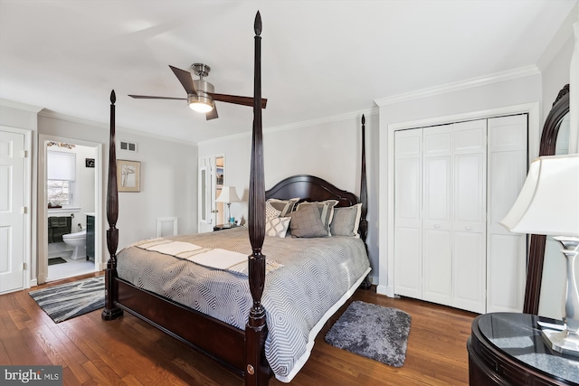 bedroom featuring ensuite bathroom, hardwood / wood-style floors, ceiling fan, crown molding, and a closet