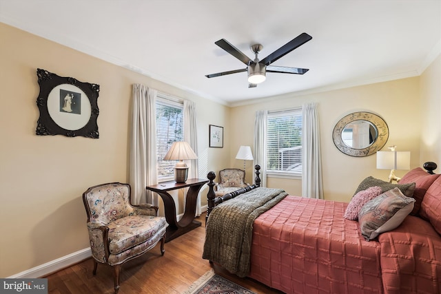 bedroom with crown molding, hardwood / wood-style floors, and ceiling fan