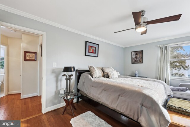 bedroom featuring ornamental molding, dark hardwood / wood-style floors, and ceiling fan