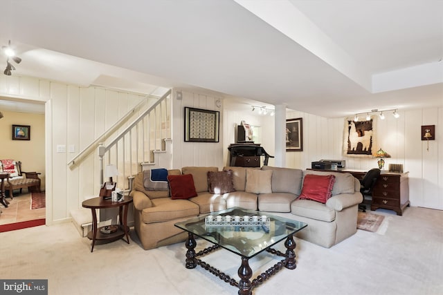 carpeted living room with track lighting