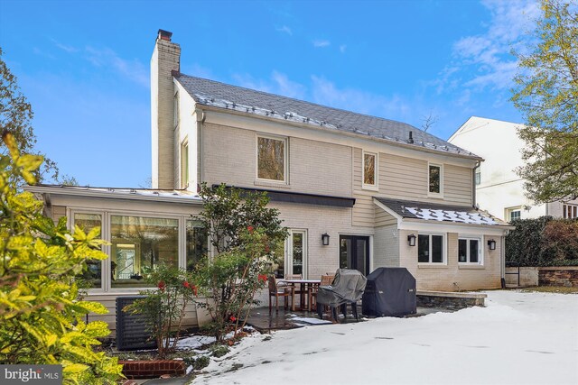 view of snow covered rear of property