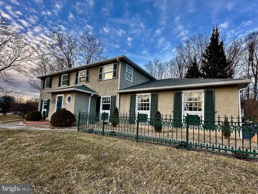 front facade with a front yard