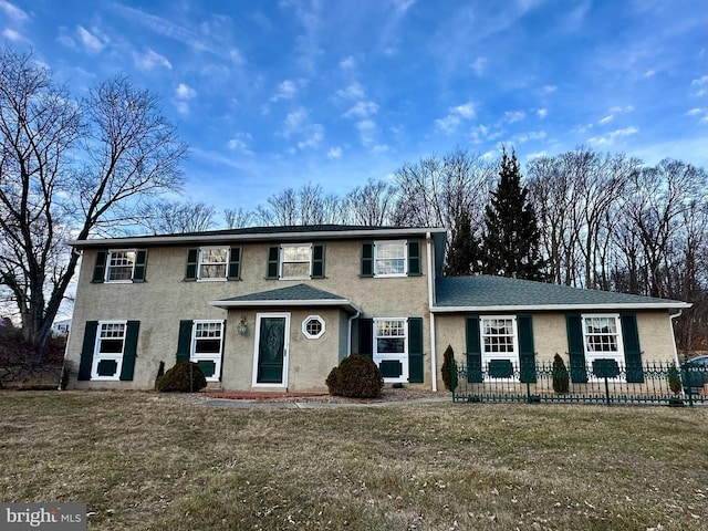 colonial home with a front yard