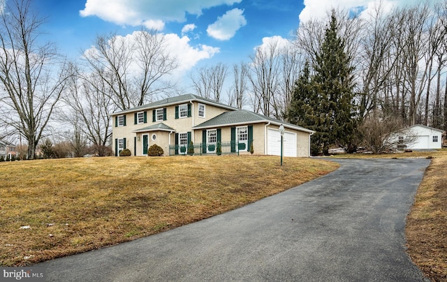 view of front of property featuring a garage and a front yard