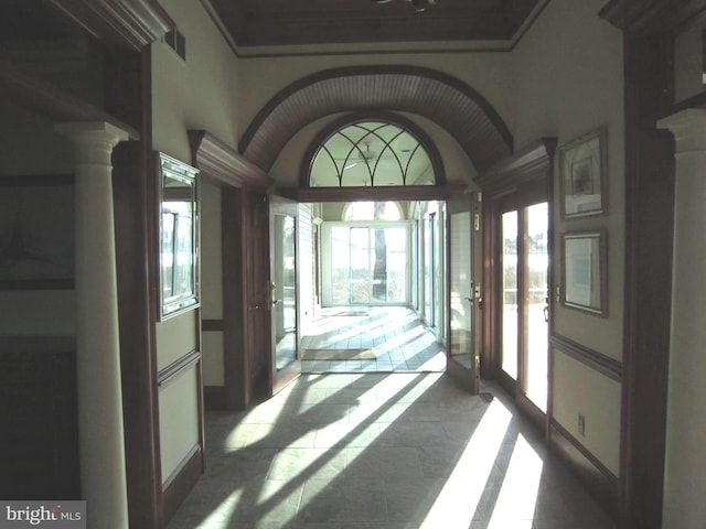 interior space featuring vaulted ceiling and decorative columns