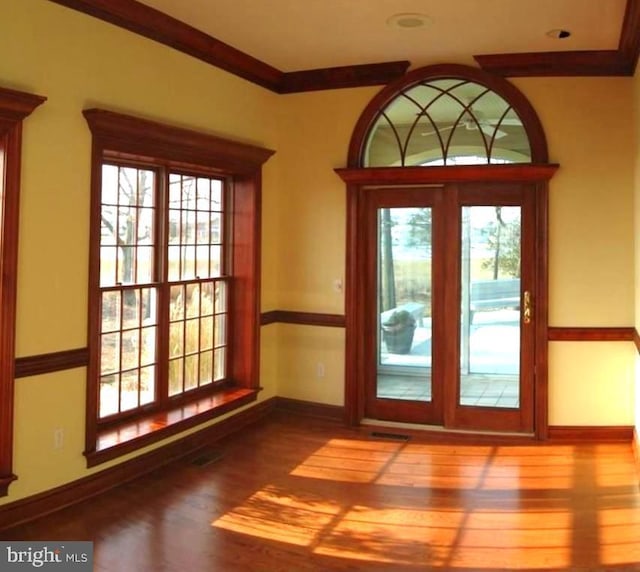 entryway with crown molding and hardwood / wood-style floors