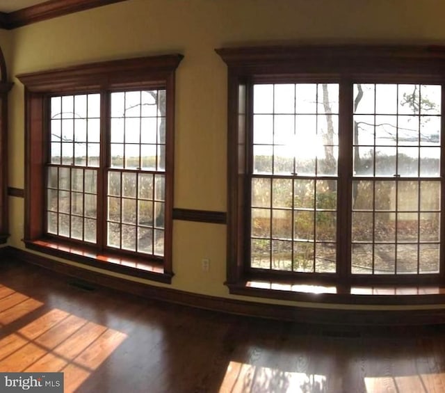 room details with hardwood / wood-style flooring and ornamental molding