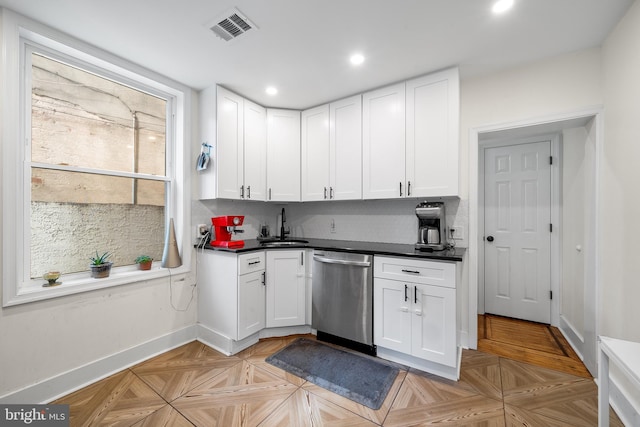 kitchen with white cabinets, light parquet floors, sink, and dishwasher