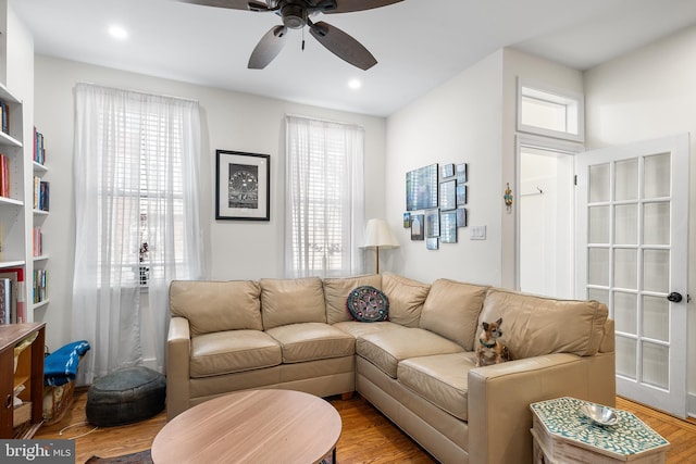 living room featuring ceiling fan and light hardwood / wood-style floors