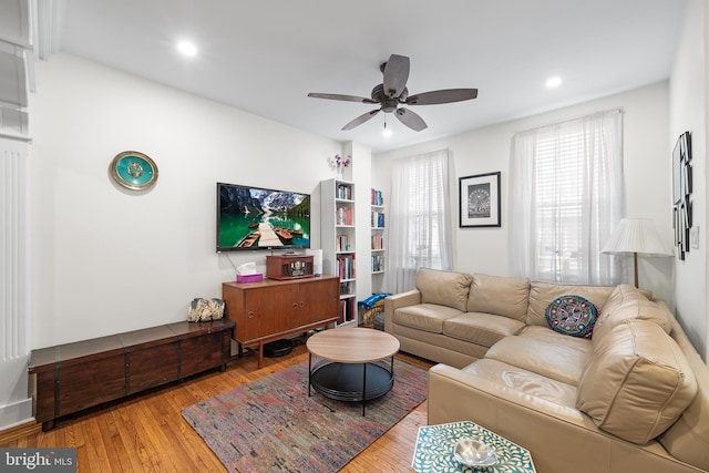 living room with ceiling fan and hardwood / wood-style floors