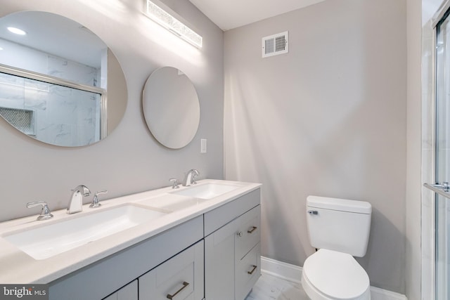 bathroom featuring an enclosed shower, vanity, and toilet