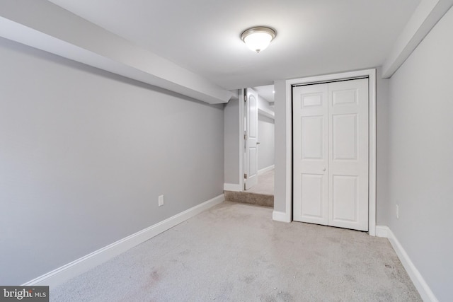 unfurnished bedroom with light carpet and a closet