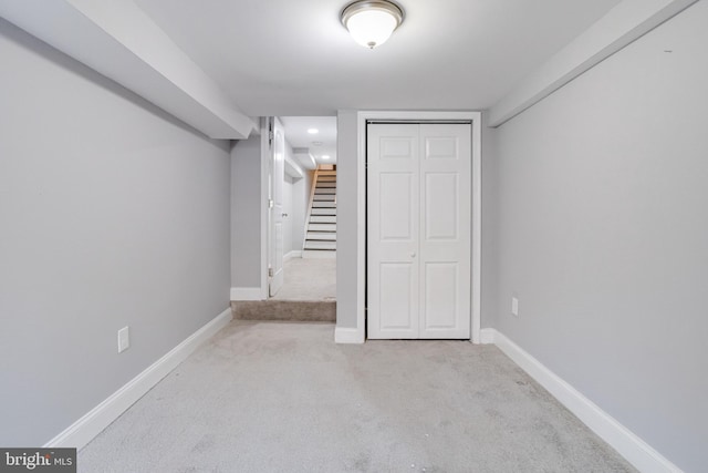 unfurnished bedroom with a closet and light carpet