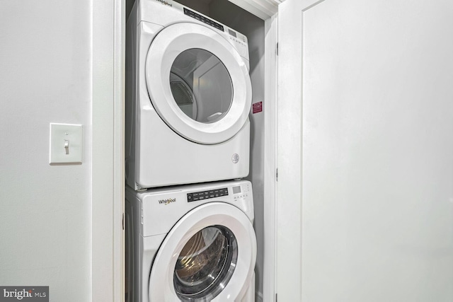 laundry room with stacked washer / dryer