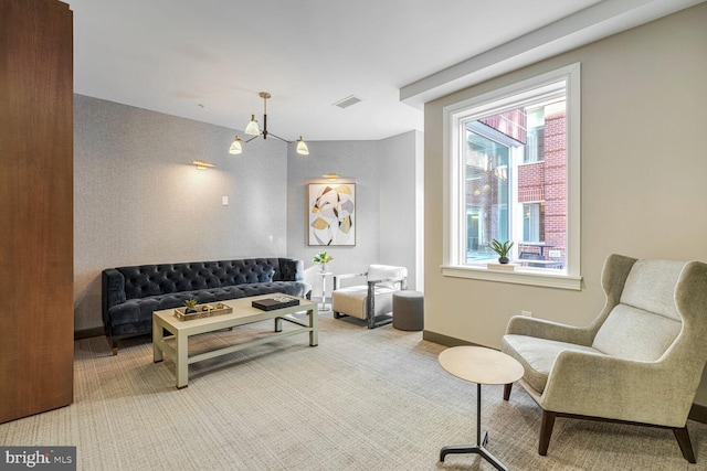 interior space with an inviting chandelier and carpet flooring