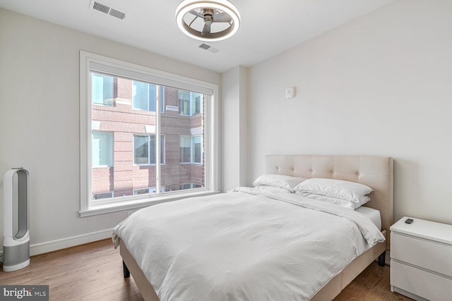 bedroom with hardwood / wood-style floors