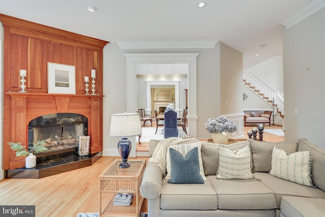 living room with hardwood / wood-style flooring and ornamental molding