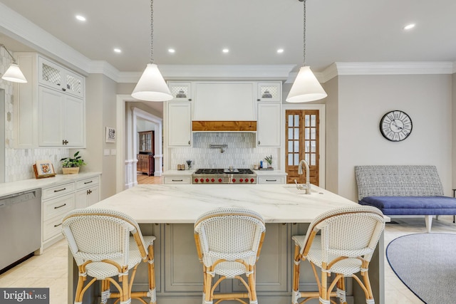 kitchen with light stone counters, a sink, white cabinetry, ornamental molding, and appliances with stainless steel finishes