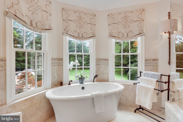 bathroom with ornamental molding, tiled bath, and tile walls