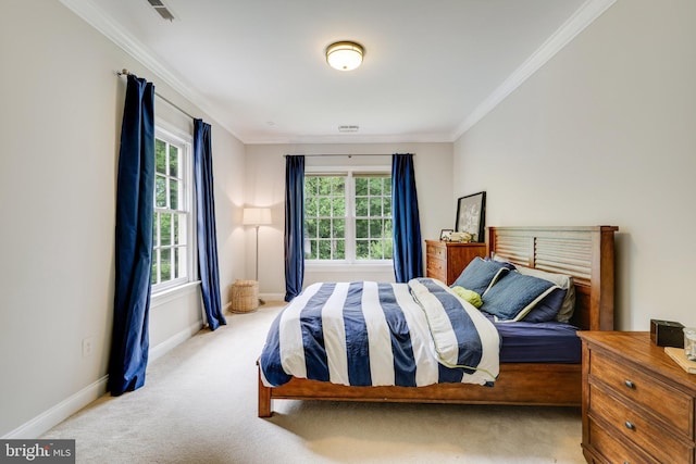 carpeted bedroom with ornamental molding, visible vents, and baseboards