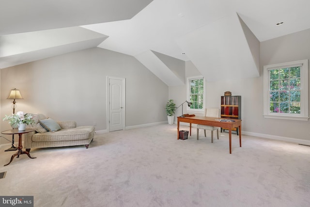 office with lofted ceiling and light colored carpet