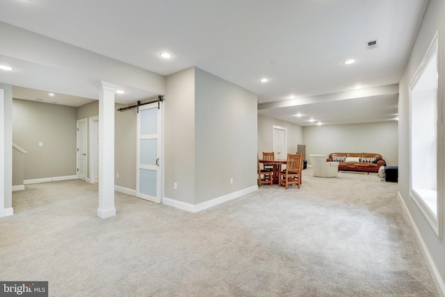 basement featuring a barn door, recessed lighting, carpet flooring, visible vents, and baseboards