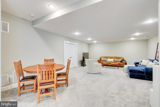 dining space with carpet floors, visible vents, and baseboards