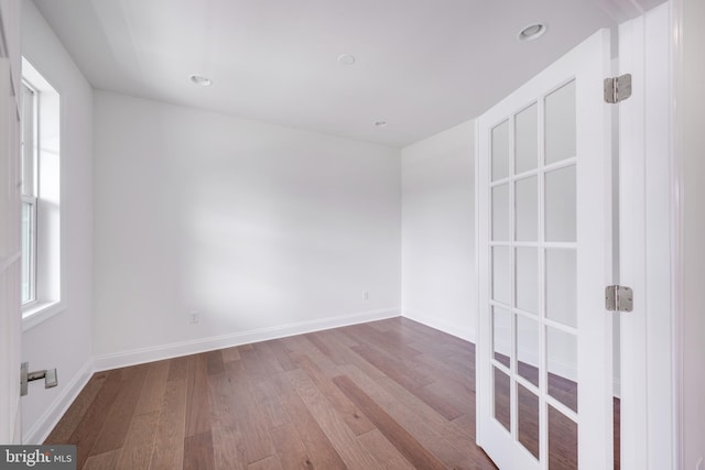 spare room with hardwood / wood-style flooring