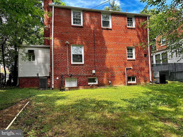 back of property featuring a lawn