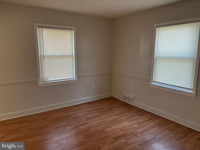 empty room with light hardwood / wood-style flooring