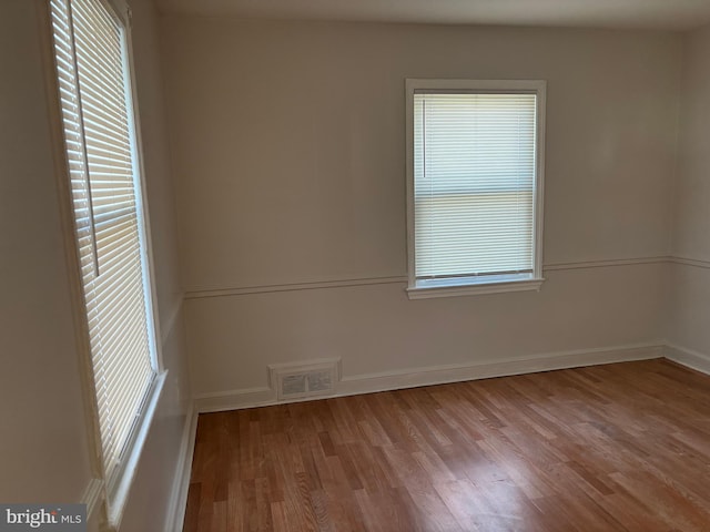 spare room with plenty of natural light and light wood-type flooring