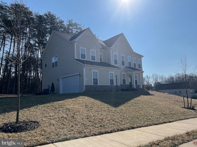 view of front of home with a garage and a front lawn