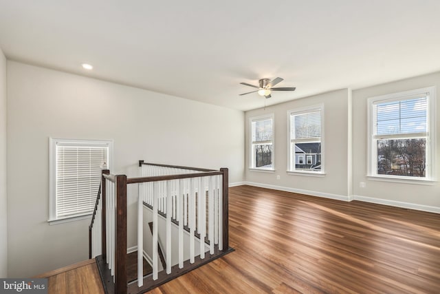 empty room featuring dark hardwood / wood-style flooring and ceiling fan