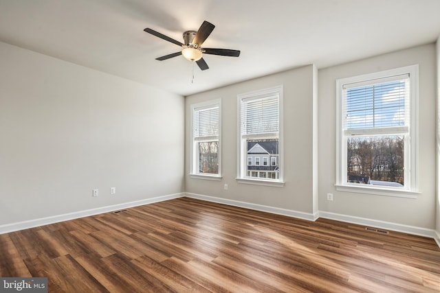 unfurnished room with a healthy amount of sunlight, hardwood / wood-style floors, and ceiling fan