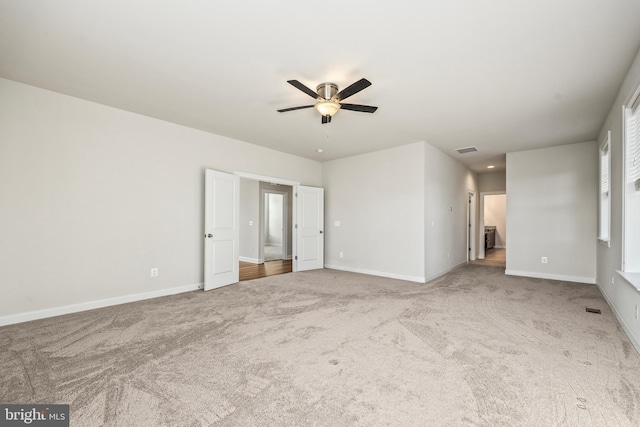 unfurnished room with carpet and ceiling fan