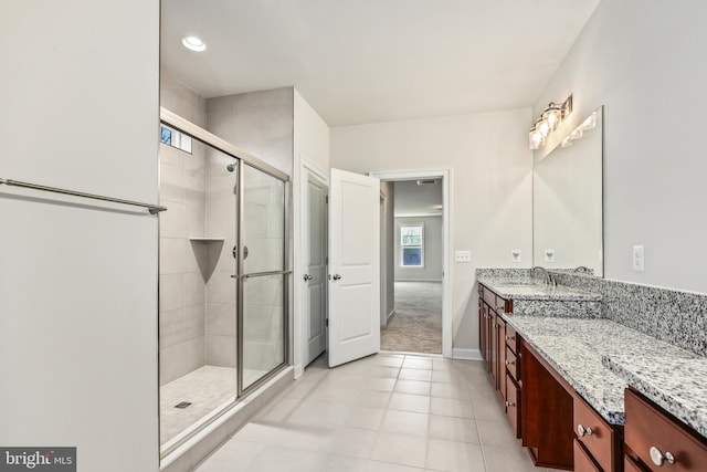 bathroom featuring tile patterned floors, vanity, and an enclosed shower