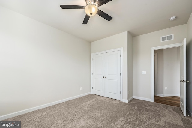 unfurnished bedroom with carpet floors, a closet, and ceiling fan