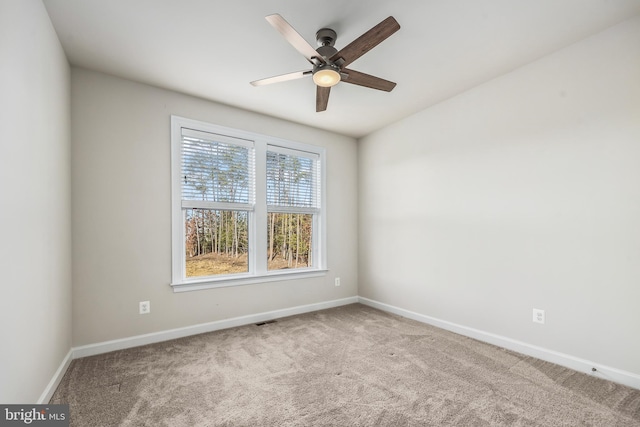 carpeted spare room with ceiling fan