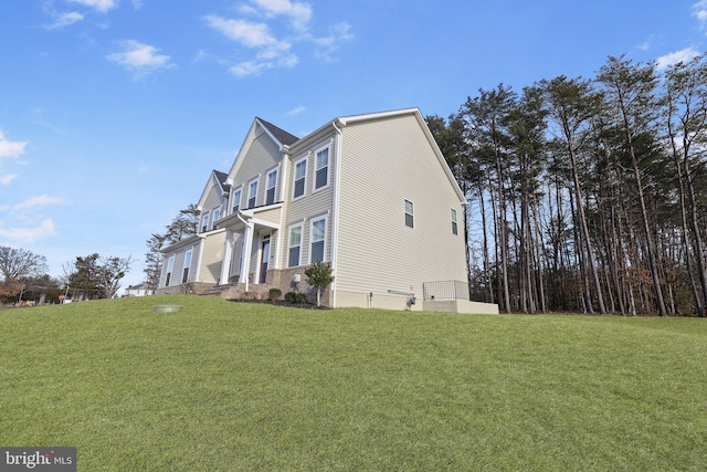 view of side of home with a lawn