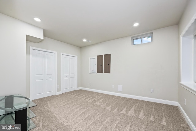 basement featuring carpet flooring and electric panel