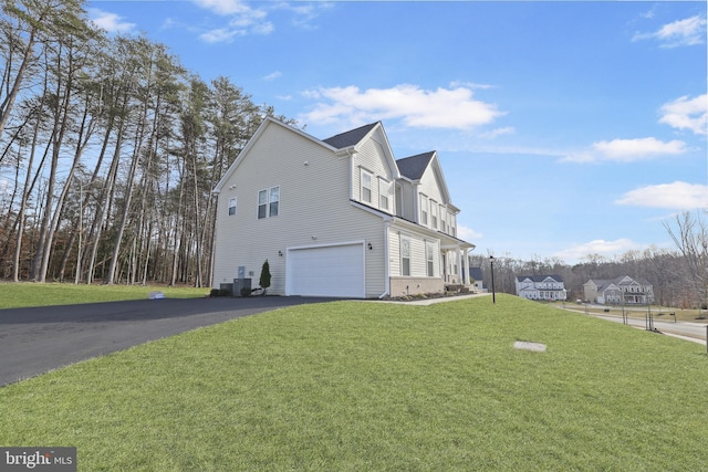 view of home's exterior with a yard and a garage