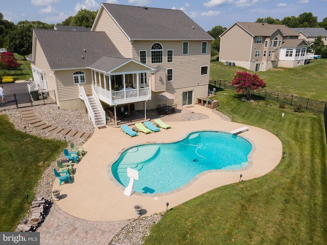 view of pool with a patio area, a fenced backyard, stairs, and a yard